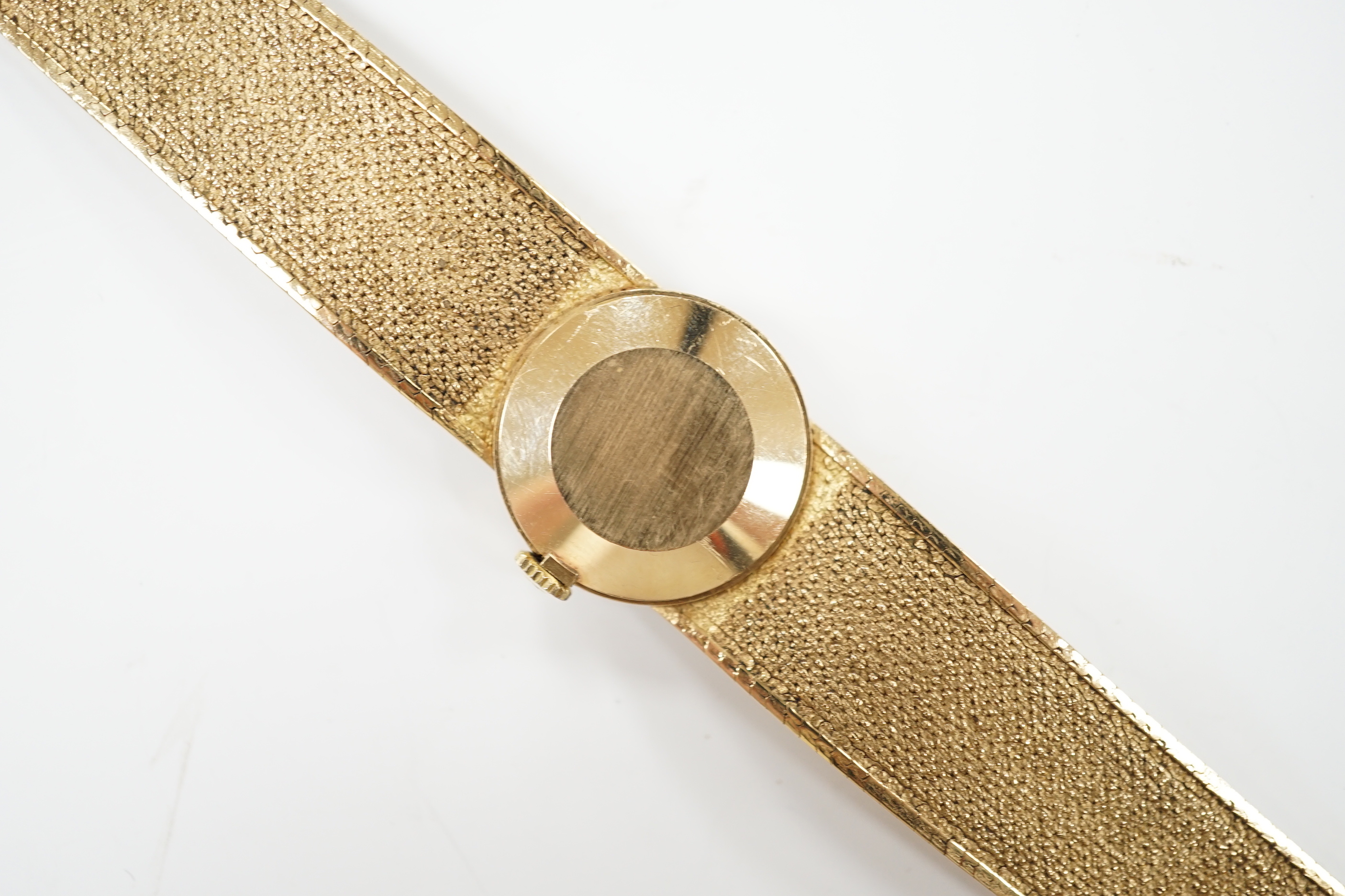 A lady's modern 9ct gold Tissot Stylist manual wind bracelet wrist watch, overall 16.5cm, gross weight 29.1 grams.